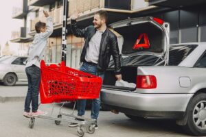 Sales man showing customer a lhd car